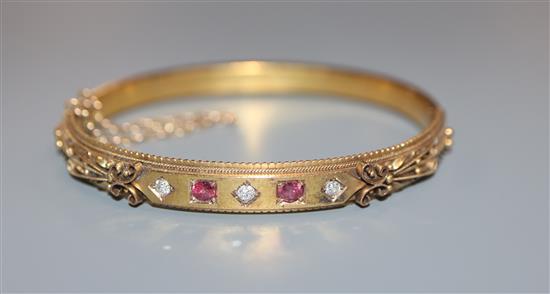 An Edwardian 15ct, ruby and diamond set hinged bracelet, gross 11.6 grams.